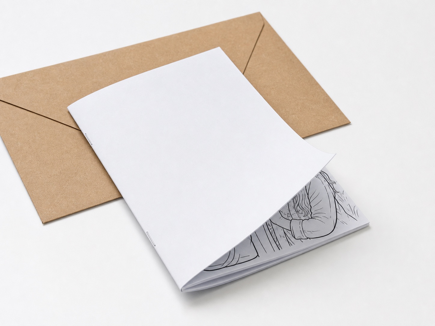 Close-up of a thin Lulu-style saddle-stitched booklet with matte cover, staples, and line-art interior pages
